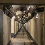 Explore a mysterious underground tunnel in Provence, France, showcasing industrial architecture and moody lighting.